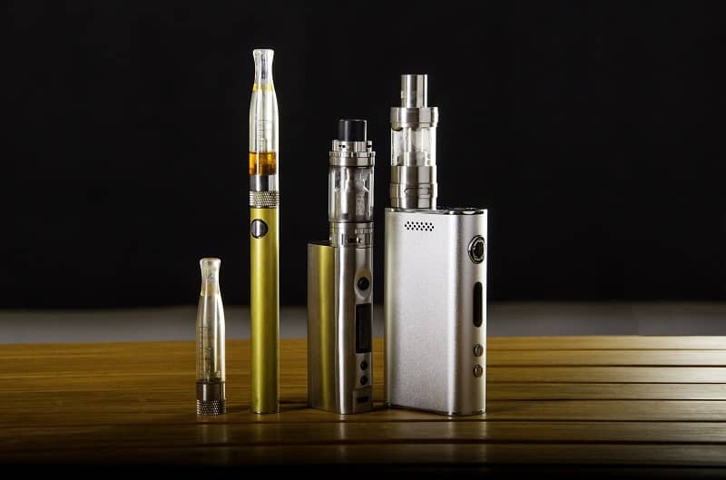 Vape devices and electronic cigarette, ecig and mods over a black background.-cm